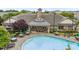 Community pool with ample seating, umbrellas, and a covered outdoor dining area at 9164 Wooden Rd, Raleigh, NC 27617