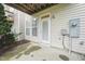 Back patio featuring a door leading to the interior, a small garden area, and the home's exterior at 9808 Rainsong Dr, Wake Forest, NC 27587