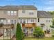View of townhome backs with decks, and backyard patios providing serene outdoor living spaces at 9808 Rainsong Dr, Wake Forest, NC 27587