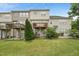 View of townhome backs with a nice lawn and deck on the second story, perfect for outdoor relaxation at 9808 Rainsong Dr, Wake Forest, NC 27587