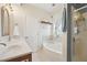 Bright bathroom featuring a soaking tub, separate shower, and a vanity with ample counter space at 9808 Rainsong Dr, Wake Forest, NC 27587