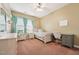 Bedroom with a desk, chair, neutral color scheme, and a large window, creating a serene and functional space at 9808 Rainsong Dr, Wake Forest, NC 27587