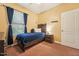 Bedroom featuring rustic wood bed frame, nightstand, and curtains adding a cozy and inviting atmosphere at 9808 Rainsong Dr, Wake Forest, NC 27587