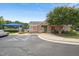 View of community clubhouse with stone accents, landscaping, and a parking lot at 9808 Rainsong Dr, Wake Forest, NC 27587