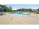 Community pool area surrounded by lounge chairs, sunshades, and trees at 9808 Rainsong Dr, Wake Forest, NC 27587