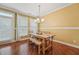 Bright dining room features hardwood floors, natural light, and stylish chandelier lighting at 9808 Rainsong Dr, Wake Forest, NC 27587