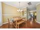 Dining room features hardwood floors and modern chandelier lighting at 9808 Rainsong Dr, Wake Forest, NC 27587