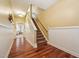 Hallway featuring hardwood floors and stairs leading to the upper level at 9808 Rainsong Dr, Wake Forest, NC 27587