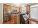 Kitchen features stainless appliances, wood cabinets, and an island bar at 9808 Rainsong Dr, Wake Forest, NC 27587