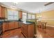 Kitchen and dining area feature hardwood floors, stainless appliances, and wood cabinets at 9808 Rainsong Dr, Wake Forest, NC 27587