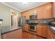 Kitchen with stainless appliances, wood cabinets, and hardwood floors at 9808 Rainsong Dr, Wake Forest, NC 27587