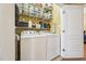 Laundry room with a washer, dryer, shelving, and an organized storage system for supplies at 9808 Rainsong Dr, Wake Forest, NC 27587