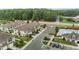 An overhead view of a neighborhood featuring townhomes, parking, green spaces, and a community pool at 1102 Latitude Dr, Durham, NC 27713