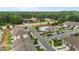 An aerial view of a townhome community, including a pool, parking, and surrounding neighborhood amenities at 1102 Latitude Dr, Durham, NC 27713