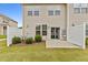 Backyard patio with privacy fence, landscaped area and sliding glass door entrance at 1102 Latitude Dr, Durham, NC 27713