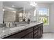 Bright bathroom with double sinks, granite countertops, and modern fixtures at 1102 Latitude Dr, Durham, NC 27713
