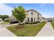 Two-story townhouse with manicured lawn and a black car parked in driveway at 1102 Latitude Dr, Durham, NC 27713
