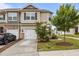 Charming townhome featuring a one car garage, neutral siding, and well manicured front yard at 1102 Latitude Dr, Durham, NC 27713