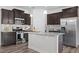 Well-equipped kitchen featuring granite countertops, stainless steel appliances, and dark cabinets at 1102 Latitude Dr, Durham, NC 27713