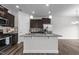 Modern kitchen with granite countertops, stainless steel appliances, and dark wood cabinets at 1102 Latitude Dr, Durham, NC 27713
