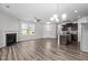Modern open-concept area with fireplace, lots of natural light, and adjoining kitchen at 1102 Latitude Dr, Durham, NC 27713