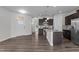 Spacious living room with an open floor plan, wood floors, and seamless flow to the kitchen at 1102 Latitude Dr, Durham, NC 27713