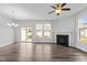 Bright living room with fireplace, ceiling fan, hardwood floors, and ample natural light at 1102 Latitude Dr, Durham, NC 27713