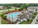 Overhead view of a large community pool area featuring lounge chairs, tables, and a clubhouse at 1102 Latitude Dr, Durham, NC 27713