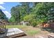 Backyard featuring a small deck and mature trees with lush greenery at 111 Mcdole Cir, Cary, NC 27511
