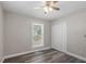 Bedroom featuring hardwood-style floors, a ceiling fan, and a double-door closet for ample storage at 111 Mcdole Cir, Cary, NC 27511