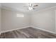 This bedroom is well-lit with wood-look flooring, crown molding, and a ceiling fan at 111 Mcdole Cir, Cary, NC 27511