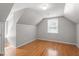 Attic bedroom with angled ceilings, hardwood floors and a ceiling fan at 111 Mcdole Cir, Cary, NC 27511