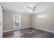 The bedroom is well-lit with windows and a ceiling fan, with wood-look floors at 111 Mcdole Cir, Cary, NC 27511