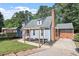 Charming home with manicured lawn, driveway, and mature trees at 111 Mcdole Cir, Cary, NC 27511