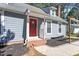 Beautiful front porch with gray siding, a red front door, and brick steps at 111 Mcdole Cir, Cary, NC 27511