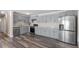 Modern kitchen with stainless steel appliances, light gray cabinets, and stone countertops at 111 Mcdole Cir, Cary, NC 27511