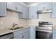 Renovated kitchen includes stainless steel appliances, stone countertops, and light grey cabinets at 111 Mcdole Cir, Cary, NC 27511