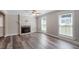 Neutral living room with a decorative fireplace, plenty of room, and natural light at 111 Mcdole Cir, Cary, NC 27511