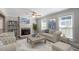 Cozy living room features neutral paint, fireplace, ceiling fan, and plenty of natural light at 111 Mcdole Cir, Cary, NC 27511