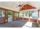 Inviting screened porch with view of wooded backyard with ceiling fan at 111 Mcdole Cir, Cary, NC 27511