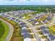 Aerial view of a neighborhood with modern homes, manicured lawns, and winding streets at 1112 Prewitt Ranch Dr, Holly Springs, NC 27540