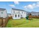 Expansive backyard featuring a play structure and a patio space at 1112 Prewitt Ranch Dr, Holly Springs, NC 27540