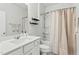 Well-lit bathroom featuring a vanity with quartz countertop, a shower-tub combo, and simple decor at 1112 Prewitt Ranch Dr, Holly Springs, NC 27540