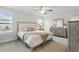 Comfortable bedroom with soft carpet, neutral decor, a ceiling fan and ample natural light at 1112 Prewitt Ranch Dr, Holly Springs, NC 27540