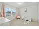 Charming bedroom with soft pink accents, comfortable furnishings, and natural light at 1112 Prewitt Ranch Dr, Holly Springs, NC 27540