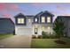 Charming two-story home featuring a well-manicured lawn, beautiful landscaping, and a classic facade at 1112 Prewitt Ranch Dr, Holly Springs, NC 27540