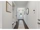 Inviting hallway with dark wood floors, light-colored walls, and stylish decor providing a warm welcome at 1112 Prewitt Ranch Dr, Holly Springs, NC 27540
