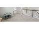 Upstairs hallway with table and chairs, leading to laundry room and bedrooms, filled with natural light at 1112 Prewitt Ranch Dr, Holly Springs, NC 27540
