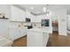 Bright, modern kitchen with white cabinets, an island, stainless steel appliances, and a pantry at 1112 Prewitt Ranch Dr, Holly Springs, NC 27540
