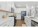 Contemporary kitchen with white cabinets, quartz countertops, and stainless steel appliances at 1112 Prewitt Ranch Dr, Holly Springs, NC 27540